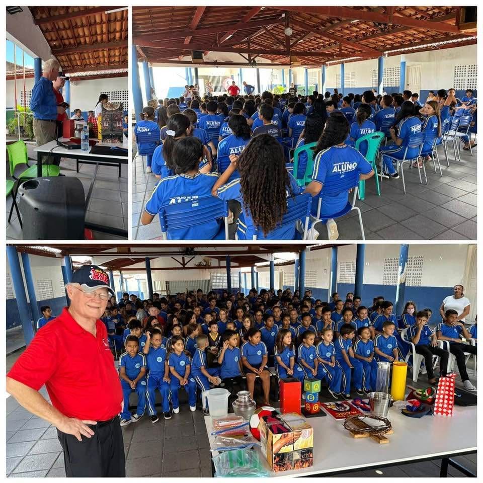 Group gathering in a covered outdoor space with attendees in blue shirts.